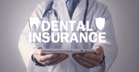 Doctor holding Dental Insurance text.