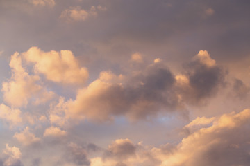 evening blue sky with clouds illuminated by the sun