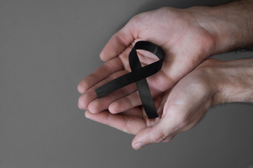 Black ribbon, symbol of melanoma ..Cancer awareness month.