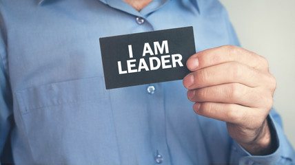 Man holding text I Am Leader on business card.