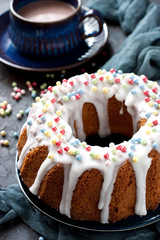 Cocoa mug and homemade cake round form with icing