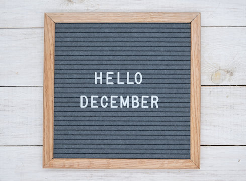 English text Hello December on a letter Board in white letters on a gray background