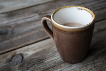 Cup of White Tea in earthen ware mug on wooden table.  Rustic shabby chic look