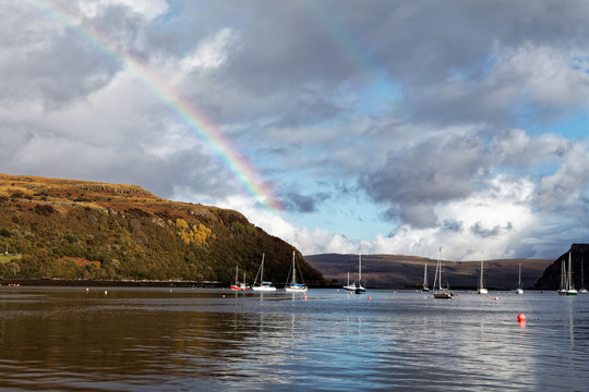 Portree bay with small boats and rainbow