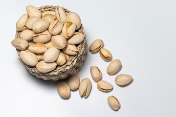 Peeled and unpeeled pistachio nuts isolated on white background