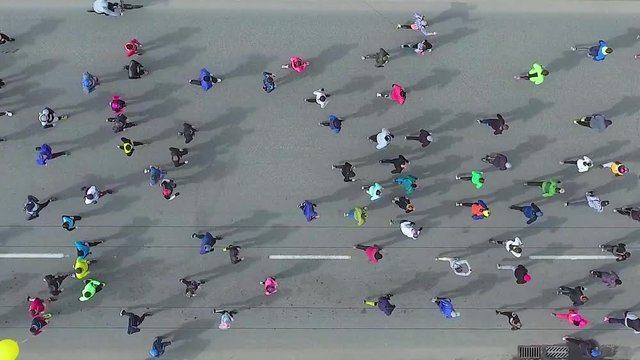 top down aerial shot of marathon runners on asphalt road