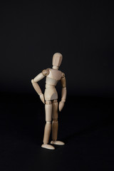 Wooden mannequin. Wooden man. Wooden mannequin on a black background.