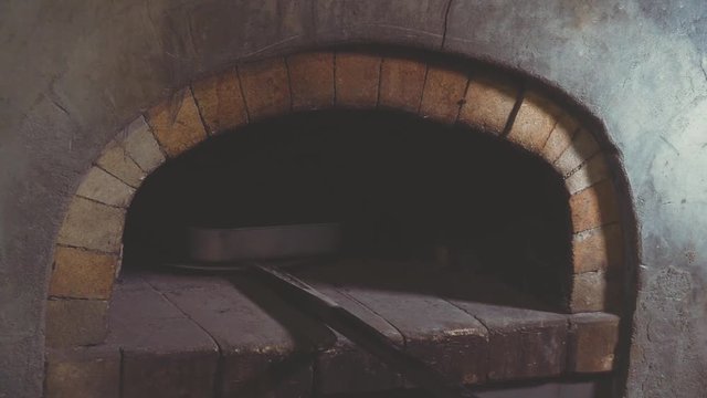 Woman Chef Baking Apple Strudel. Female Hands Take Tray with Pastry out of Brick Oven