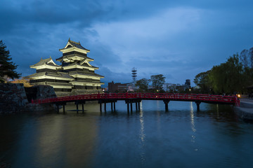 Matsumoto Castle with the red bridge at night in Matsumoto, Japan