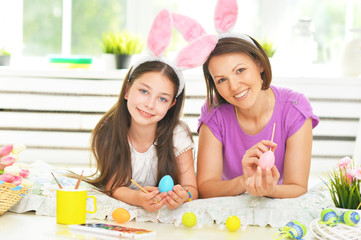 Portrait of mother and daughter with Easter eggs