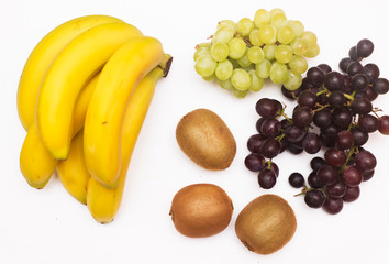 Various mix of fruit from top on white background. Bananas, Grapes and Kiwi