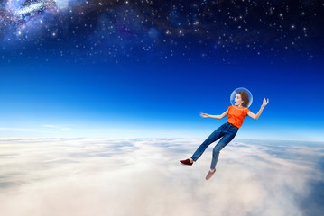 Fototapeta na wymiar Young woman falling down from space in clouds sea.