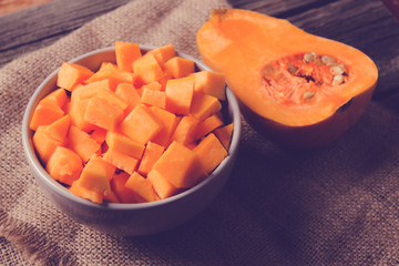 ingredients for pumpkin soup on a wooden background
