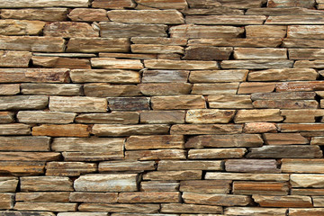 Rough textured wall created using flat rocks