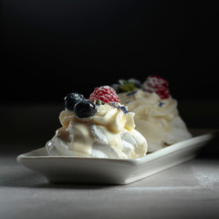 Dessert Pavlova with blueberries and raspberries.