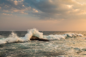 Storm waves in sunset at a tropical resort.