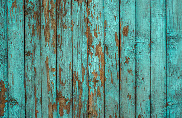 Blue painted plank fence with cracked and scratch. Horizontal grunge texture