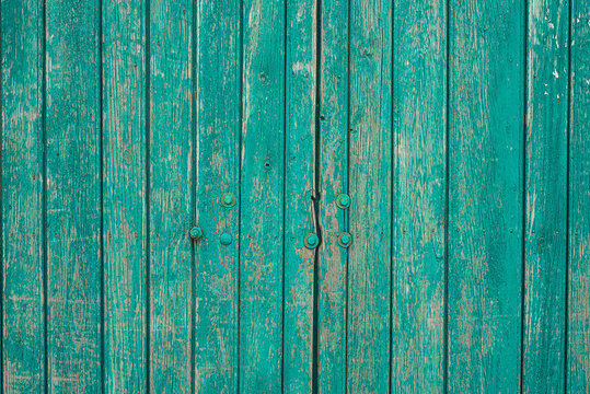 Blue painted plank fence with cracked, nails and scratch. Horizontal grunge texture
