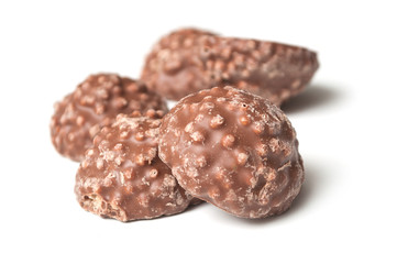 closeup of milk chocolate in shaped rock on white background