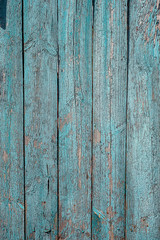 Blue painted plank fence with cracked, nails and scratch. Vertical retro texture
