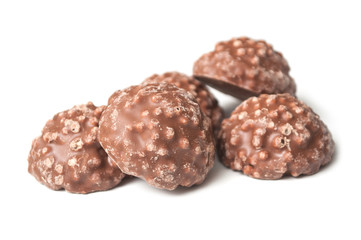 closeup of milk chocolate in shaped rock on white background