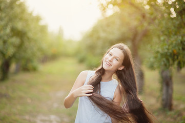 Naklejka premium girl in orchard. garden with flowering trees. Allergy season. Dancing jumps