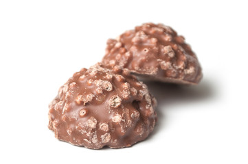 closeup of milk chocolate in shaped rock on white background
