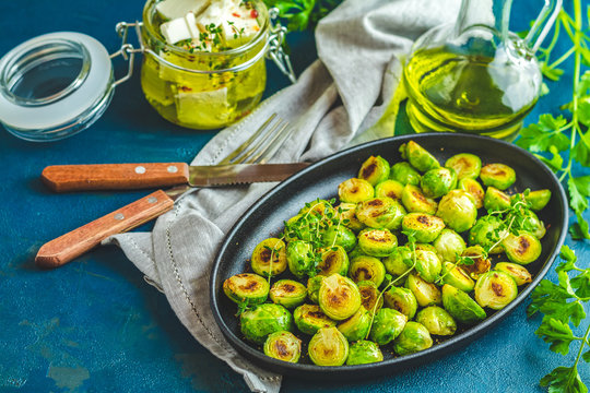 Black plate with delicious roasted Brussels sprouts