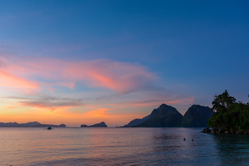 Naklejka na ściany i meble El Nido Philippines, Asia -Colorful sunset over the sea