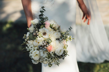 wedding bouquet in hands of bride