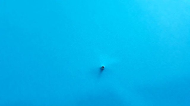 A bolt from the blue idiom something important or unusual that happens suddenly or unexpectedly closeup steel bolt  screw appearing from blue color background