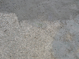 Gray plastered wall with a glass crumb background texture