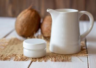 Coconuts and coconut milk. Wooden background.