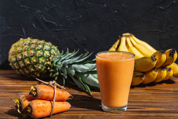 Colorful smoothie, healthy detox vitamin diet or vegan food concept, fresh vitamins, breakfast drink with pineapple, apple, banana, carrot