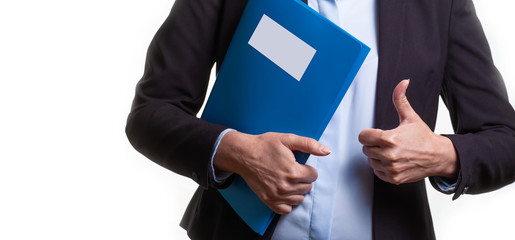 Young woman in a business suit holding a file or a binder. Copy space.