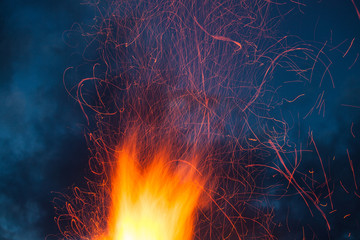 Big camp fire sparks at night long exposure