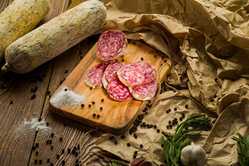 sliced salami sausage on a kitchen board