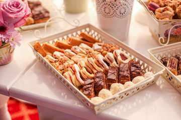 Delicious cnady bar with colored macaroons, cupcakes and other sweets