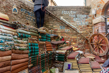 Fototapeta premium Italy, Venice, heap of old books in an open garden.