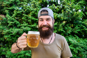 Creative young brewer. Craft beer is young, urban and fashionable. Distinct beer culture. Hipster brutal bearded man hold mug cold fresh beer. Man enjoying beer in summer. Alcohol and bar concept