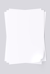 Blank sheets of white paper isolated on gray background. 3d image