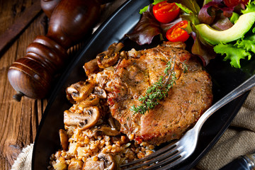 Pork steak with mushrooms and buckwheat groats and mango salad