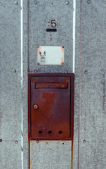 Rusty mail box on metal outdoor galvanized iron door