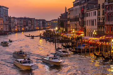 Italy, Venice, view of the Grand Canal at sunset with boats and gondolas.