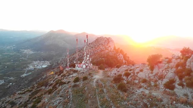 Aerial drone view of telecommunication antennas at sunset, in Segaria mountain, in Marina Alta, Alicante, Spain