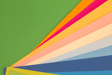 sheets of colored paper. Many colored sheets of paper are laid out in the harsh composition. background of colored paper.