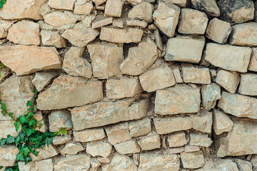 Texture of old stone wall. Surface from grey rocks, built witout cement