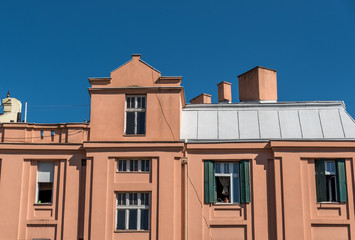 Old residential building windows and exterior facade with blue sky above in the city of Belgrade, Serbia 