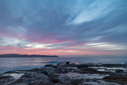 High Cloud Pink Dawn Seascape from Rock Platform