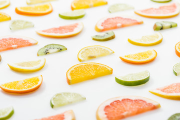 Fototapeta na wymiar Juicy fresh sliced citrus fruits on white surface